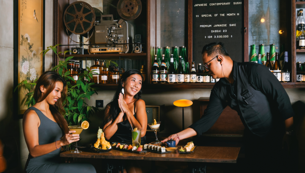 Guests enjoying sushi and cocktails at Kajin contemporary Japanese restaurant in Bali